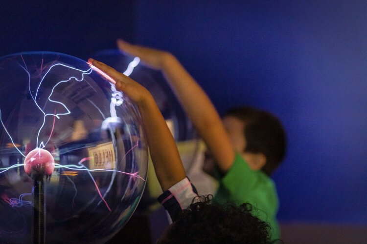 Alma College Head Start Program preschoolers interact with plasma balls in the "Luminary Lab" at the Mount Pleasant Discovery Museum. The Luminary Lab helps introduce children to the qualities of light.