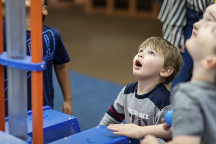 An Alma College Head Start Program preschooler reacts to a ball being launched into the air at the Mount Pleasant Discovery Museum.