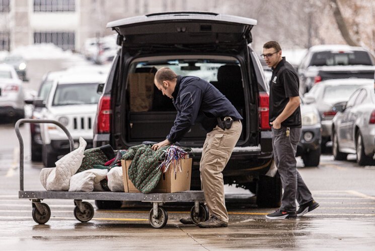 Mount Pleasant City Police Officer Justin Nau helps unload donated items from a van Dec. 3 at Finch Fieldhouse on Central Michigan University's campus.