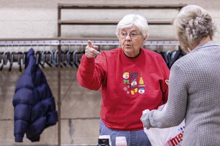 Mount Pleasant resident Eileen Jennings, 77, points out additional work to be done during Christmas Outreach set-up Dec. 3 at Finch Fieldhouse on Central Michigan University's campus. Jennings has been involved in Christmas Outreach for 25 years.