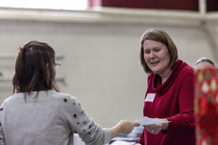 Alma resident Tina Campbell, 41, helps distribute items during Christmas Outreach Dec. 6 at Finch Fieldhouse on Central Michigan University's campus.