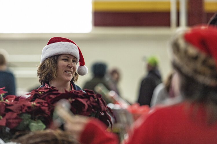 Sacred Heart Academy teacher Karon Latham, 46, helps Christmas Outreach participants find holiday items Dec. 6 at Finch Fieldhouse on Central Michigan University's campus.