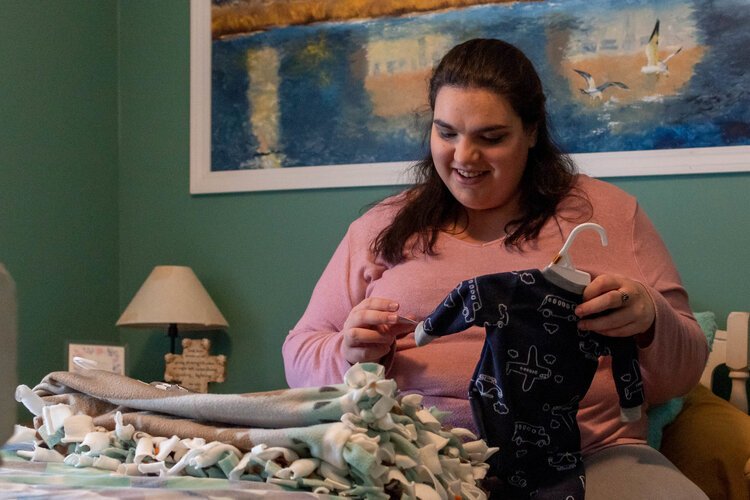 In her bedroom at the Joshua's House shelter, Talissa Clark, 21, picks out the first outfit her son will wear nine days before her due date on Monday, Nov. 11. 