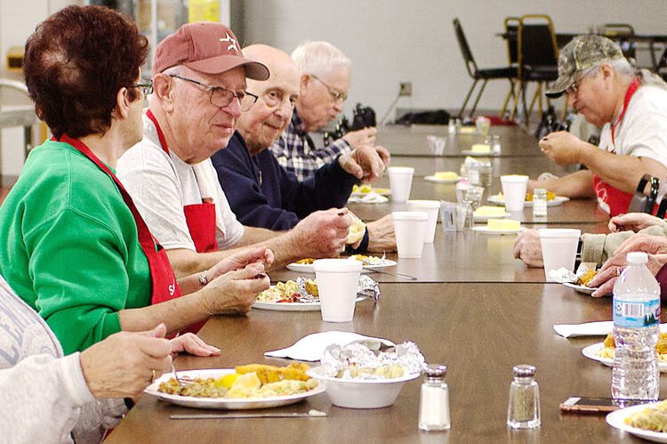 Second from the left, Don Hire helps with Sacred Heart Parish's Lenten fish fry.