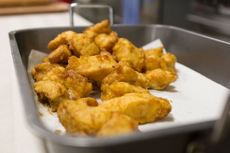 Fish fresh out of the fryer rests momentarily in the kitchen at Sacred Heart