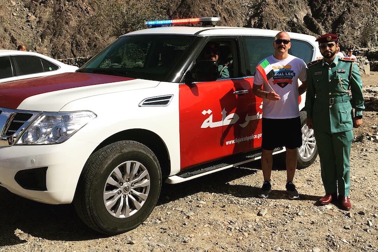 Sergeant Riley Olson poses for a photo with fellow law enforcement officers from the UAE during his trip with Law Enforcement Torch Run