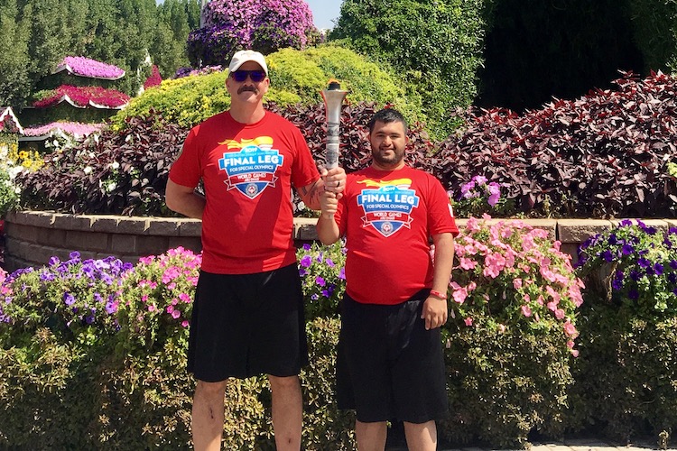 Sergeant Riley Olson poses for a photo with a Special Olympics World Games 2019 athlete during his trip to the UAE with Law Enforcement Torch Run