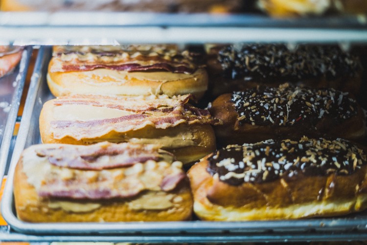 The Bacon Squealer: a Long John doughnut layered with two pieces of bacon on top.