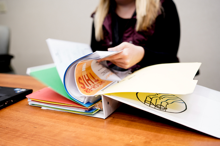 Taylor Idema flips through a manual