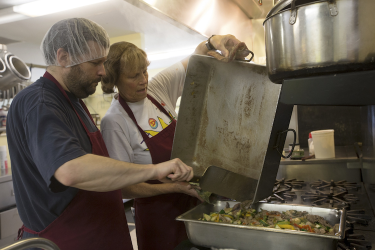 Isabella Community Soup Kitchen volunteers Chris Holtz and Maredda Magnus prepare steak fajitas for lunch at the soup kitchen on Friday, Jan. 4, 2019.