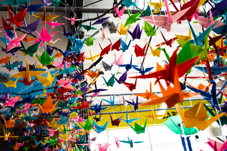 Brightly colored paper cranes hang inside the museum