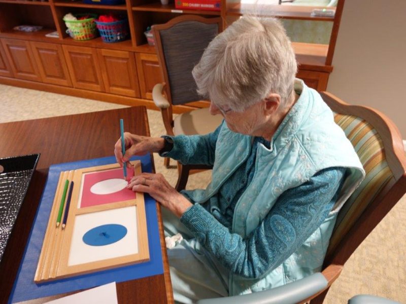 A resident participates in montessori activities