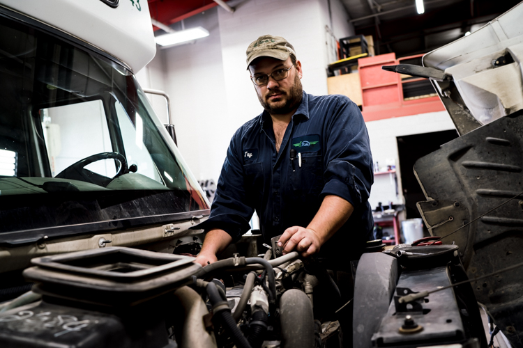 A mechanic works on one of the 45 vehicles in iRide's fleet