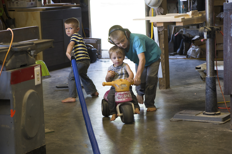 Three of the Bosko boys play in their Dad's woodworking shop