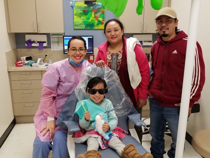 A student and her parents following a dental checkup at the Cincinnati Health Department.