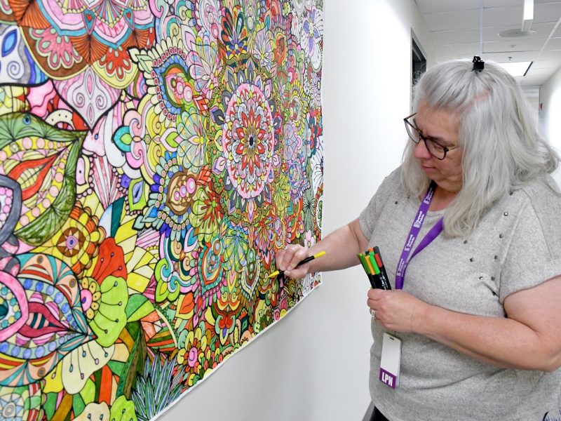 Kim Hargis, LPN works on a mandala mural at Summit Pointe.