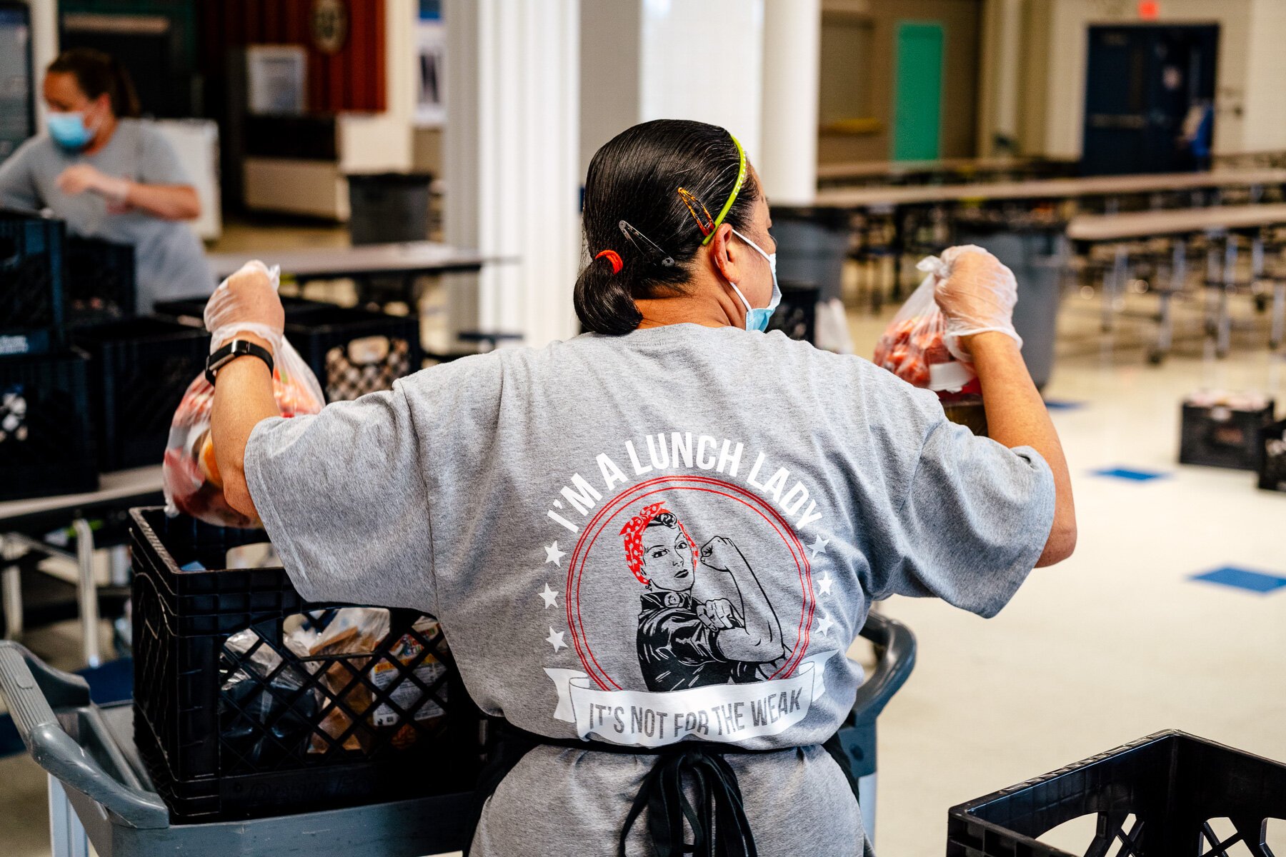 A Plymouth-Canton Community Schools staffer prepares meals for pickup.