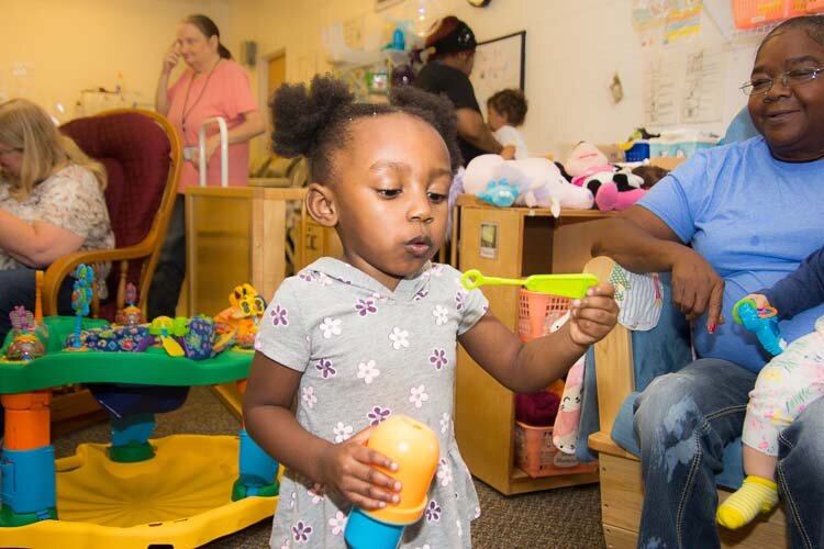 A child plays at the Kalamazoo Drop-In Child Care Center.