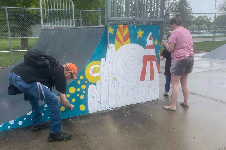 Community members painted ramps decorated "paint-by-numbers" style during the Paint and Skate event at the Island Park skatepark in downtown Mt. Pleasant on Saturday, May 13, 2023. (Photo courtesy of Megan Bair)