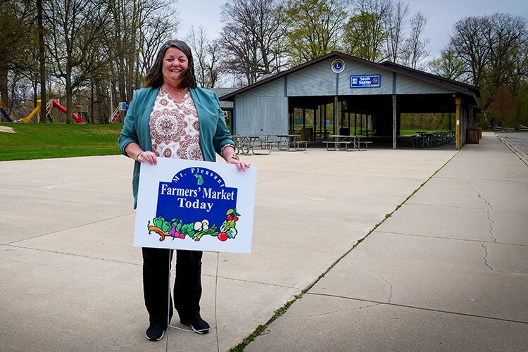 Carol Moody, recreation coordinator at Mt. Pleasant Parks & Recreation and the Mt. Pleasant Farmers' Market market manager, prepares for the market's 50th season at Island Park in downtown Mt. Pleasant, Michigan. (Photo: Courtney Jerome/Epicenter)